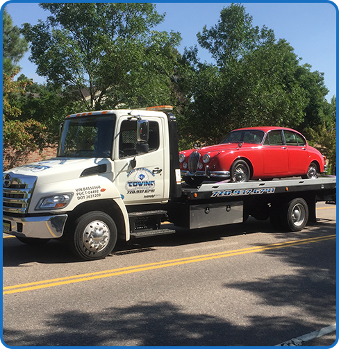 Roadside assistance given to the classic red car in Aurora, CO.